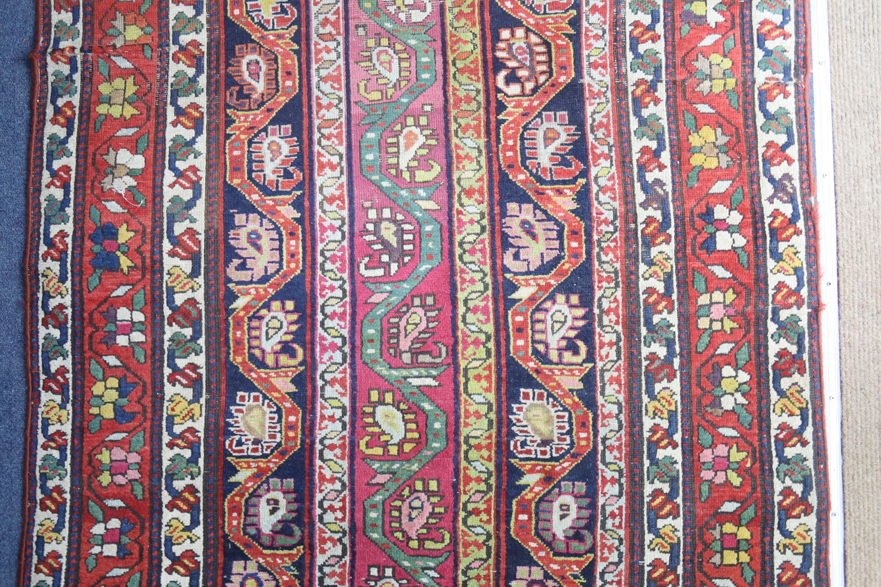 A Caucasian design Boteh red ground rug, 236 x 116cm